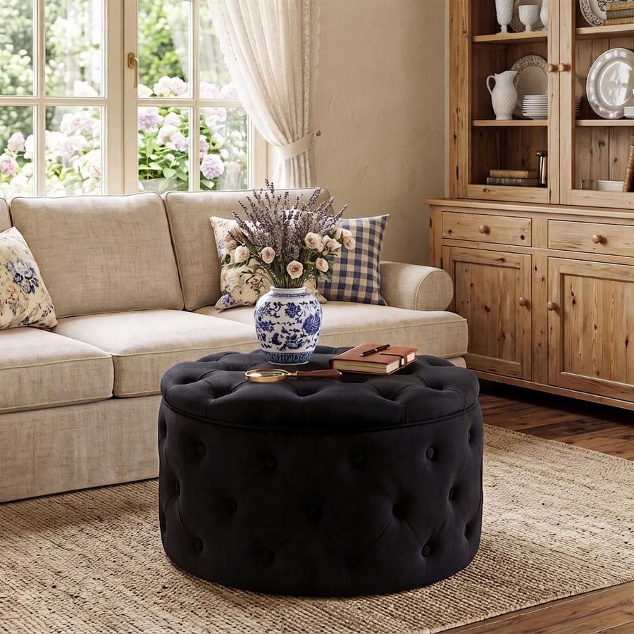 Black velvet round storage ottoman with lid lifted off, wooden tray and two mu